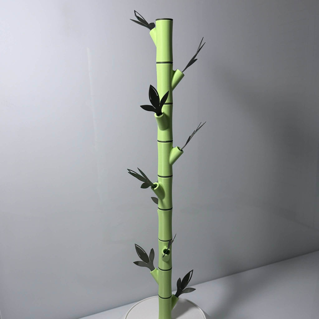 bamboo polaroid holder with empty offshoots in lime green and dark green in a white vase