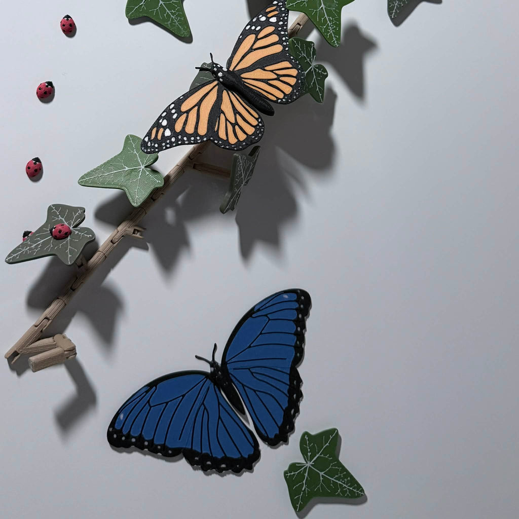 blue morpho, orange monarch, red ladybug, and green leave magnets